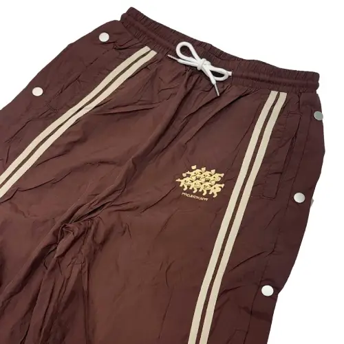 Model wearing Project Capri Running Man Track Pants Brown side profile view